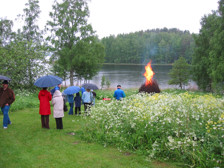 Ihmisiä juhannuskokkoa katsomassa
